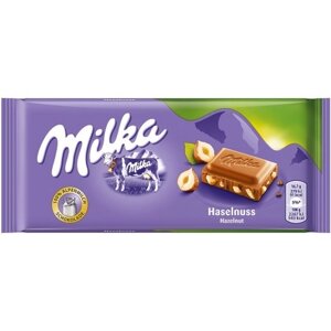 Шоколад молочний плитка Milka Haselnuss з лісовими горіхами 100г